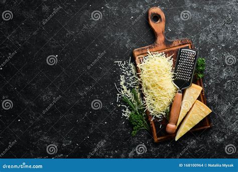 Grated Hard Cheese On A Black Stone Background Parmesan Top View