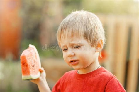 Funny Kid Eating Watermelon Outdoors In Summer Park Stock Image