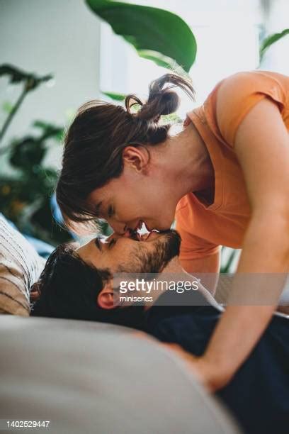 Couple Kissing Couch Photos And Premium High Res Pictures Getty Images