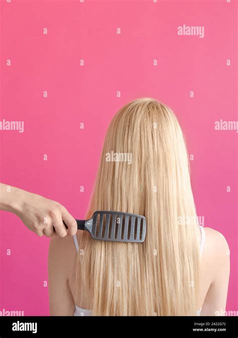 Combing Hair Beauty Concept Womans Hand Is Combing Long Blonde Hair