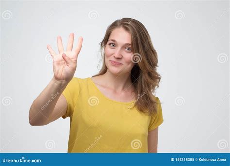 Pretty Caucasian Young Woman Holding Up Four Fingers Stock Image