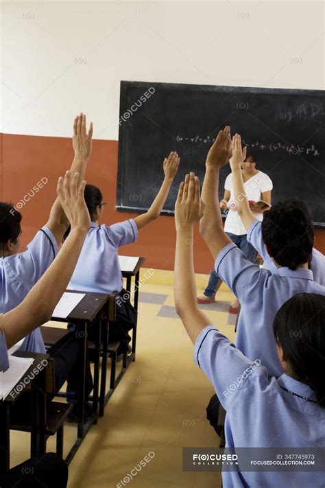 Students Raising Their Hands In A Classroom — Teaching Standing