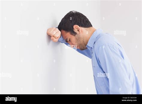 Upset Man Leaning His Head Against A Wall Stock Photo Alamy