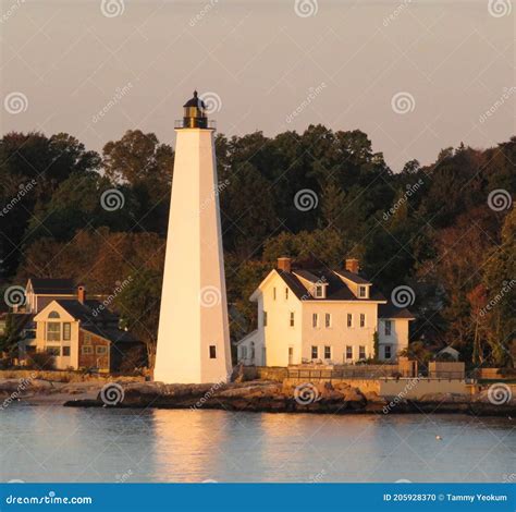 Historic Colonial New England Lighthouse At Sunrise Stock Photo