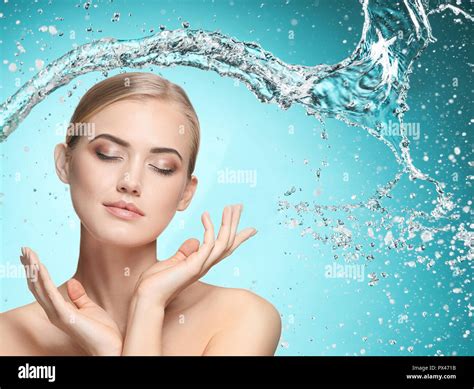 beautiful woman with splashes of water in her hands beautiful girl under splash of water with