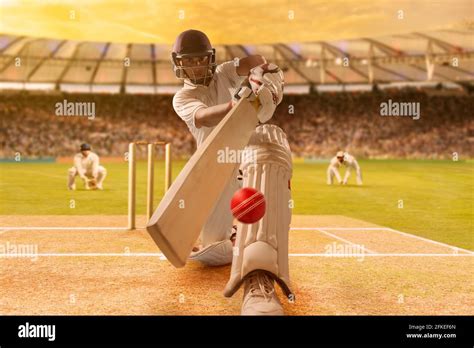 Batsman Hitting The Ball During Cricket Match In Stadium Stock Photo