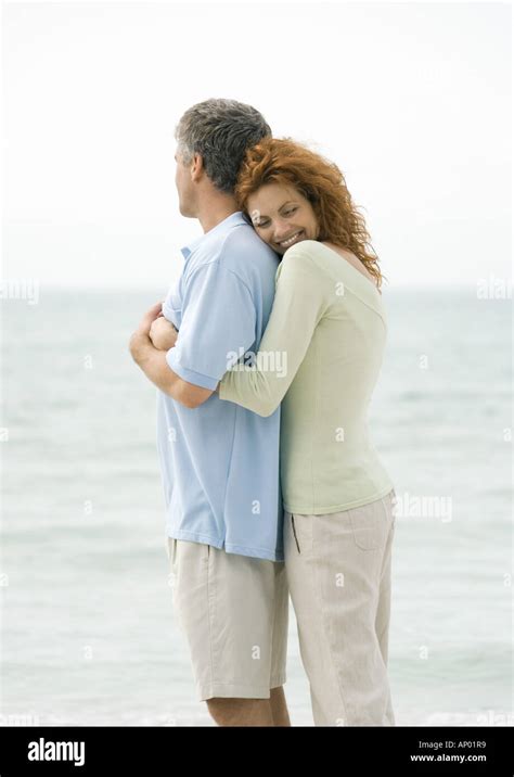 Mature Couple Woman Hugging Man From Behind Stock Photo Alamy