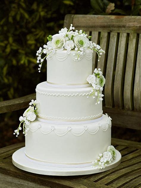 White Wedding Cake With Ranunculus Roses And Lily Of The Cakesdecor