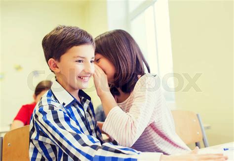 Smiling Schoolgirl Whispering To Classmate Ear Stock Image Colourbox