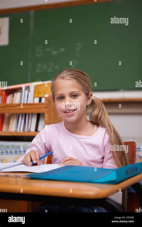 Portrait Of A Cute Schoolgirl Writing Stock Photo Alamy