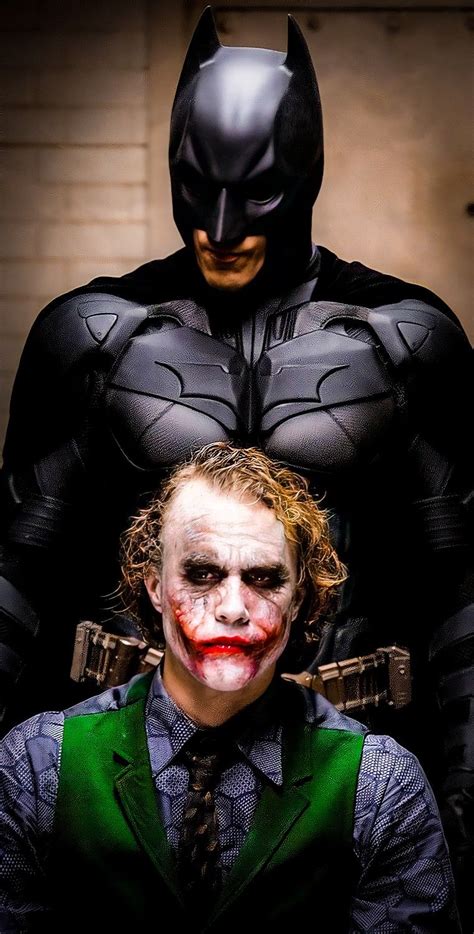 Two Men Dressed Up As Batman And Joker