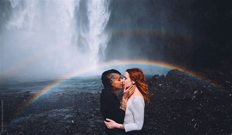 Couple Of Woman Kissing In Front Of A Waterfall By Thais Varela Love