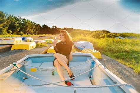 beautiful woman sitting on the boat people images ~ creative market