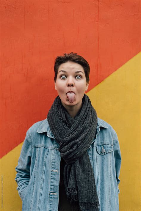 stylish woman showing tongue by stocksy contributor alina hvostikova stocksy