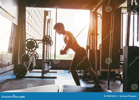 Fitness Strong Man Doing Heavy Weight Exercise On Machine In Gym Stock