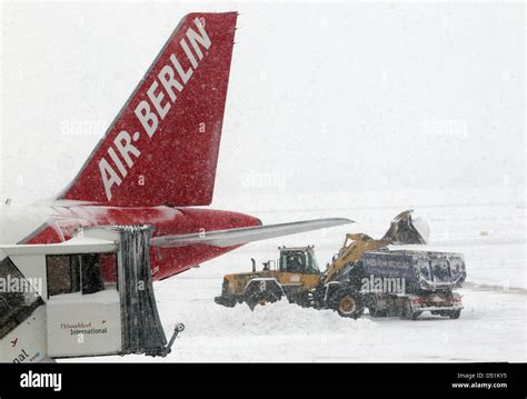 The Airport Employees Try To Clear The Runways Of Snow With Heavy Equipment In Duesseldorf