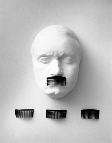 Three Combs Are Placed In Front Of A White Mask With Four Faces On It