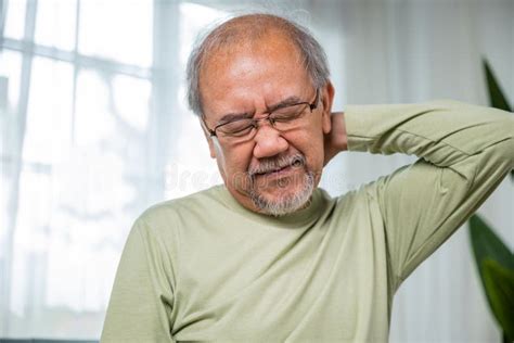 Old Man Suffering From Nape Neck Pain At Home Stock Image Image Of