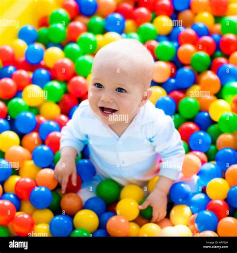 Happy Laughing Boy Having Fun In Ball Pit On Birthday Party In Kids