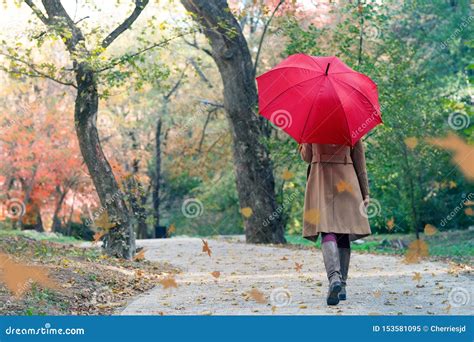 woman with red umbrella walking at the rain in beautiful autumn park stock image image of