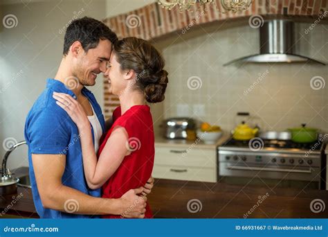 Romantic Couple Standing Face To Face And Embracing Each Other Stock