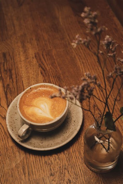 This outlet has a unique outdoor seating area with thatched roofs made of straw sheltering each table, and abundant lush trees around. coffee cup photo - Free Coffee cup Image on Unsplash