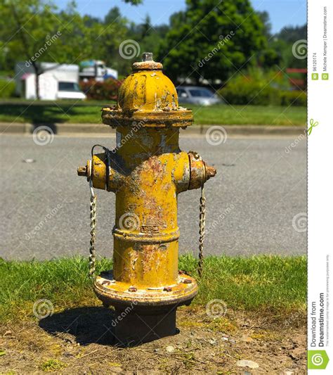 What color are fire hydrants? Yellow Fire Hydrant With Peeling Paint Stock Photo - Image ...