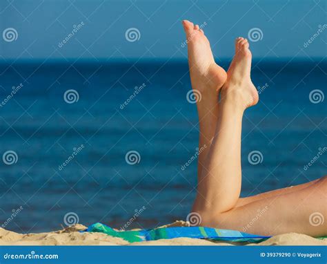 Summer Vacation Legs Of Sunbathing Girl On Beach Stock Photo Image