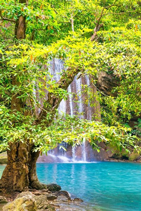 Waterfall In Tropical Forest With Green Tree And Emerald Lake Erawan