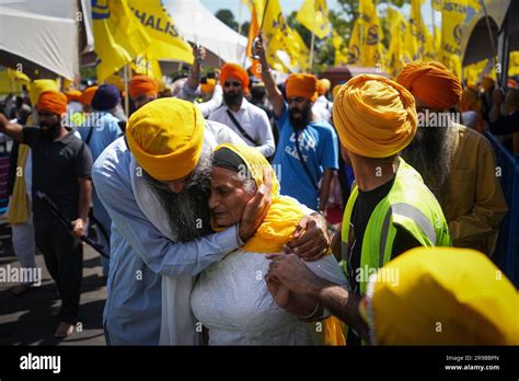 Surrey, Canada. 25th June, 2023. A woman is consoled as people mourn