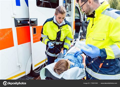 Paramedics Measuring Blood Pressure Of Injured Boy — Stock Photo