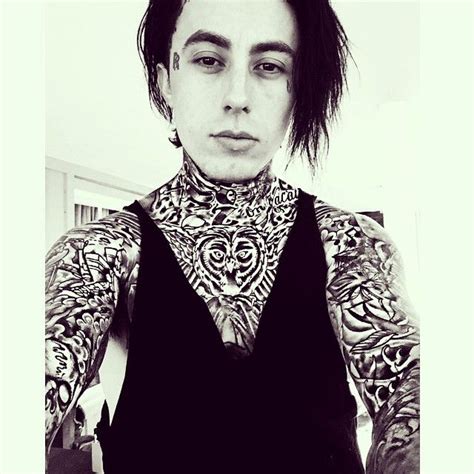 A Man With Tattoos On His Chest And Neck