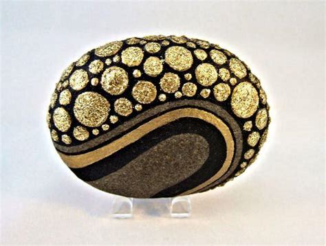 It's a golden buddha statue. Unique 3D Art Object OOAK Painted Rock Black Gold by ...