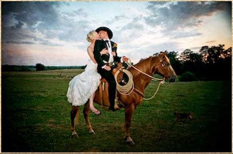 A Bride And Groom Riding On The Back Of A Horse In A Field At Sunset
