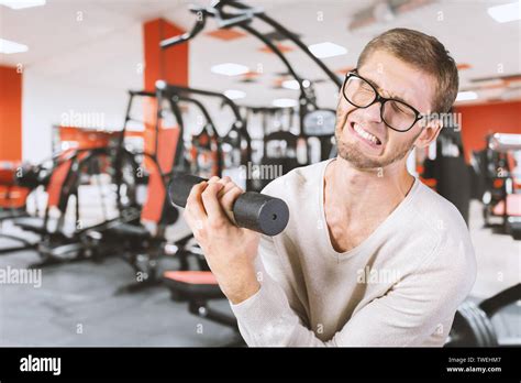Funny Weak Man Tries To Lift A Weight Stock Photo Alamy
