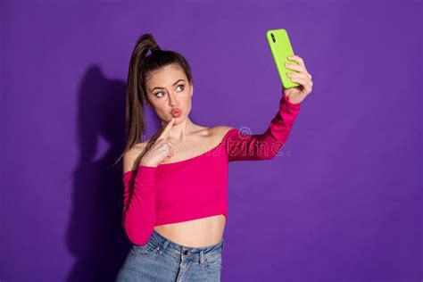 photo of blogger girl hold cellphone make selfie finger face wear pink top isolated purple color