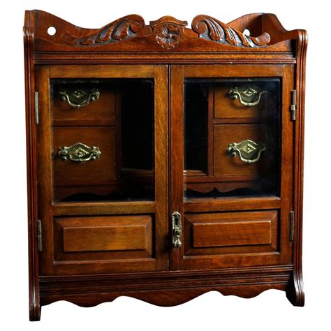 Looking for humidor cabinets to place in personal smoking rooms, hotel lounges, clubs or point of sale locations? Antique Victorian Carved Oak Double Door Tobacco Cabinet ...