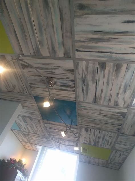 The solid color borders painted on the ridges and around the edges of the ceiling could easily be replicated on a flat ceiling by just taping off a similar x design and painting it a solid color. diy pallet board ceiling in place of drop ceiling tiles ...