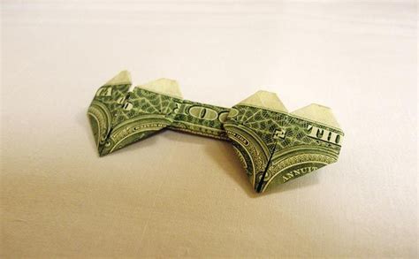 An Origami Dollar Bill Shaped Like A Bat