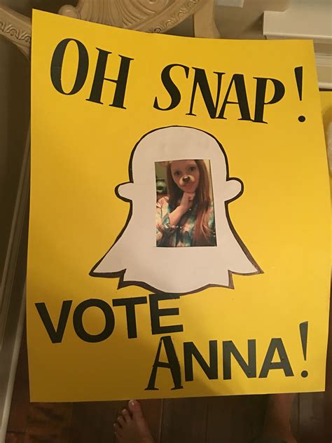 A Person Holding Up A Yellow Sign That Says Oh Snap Vote Anna On It