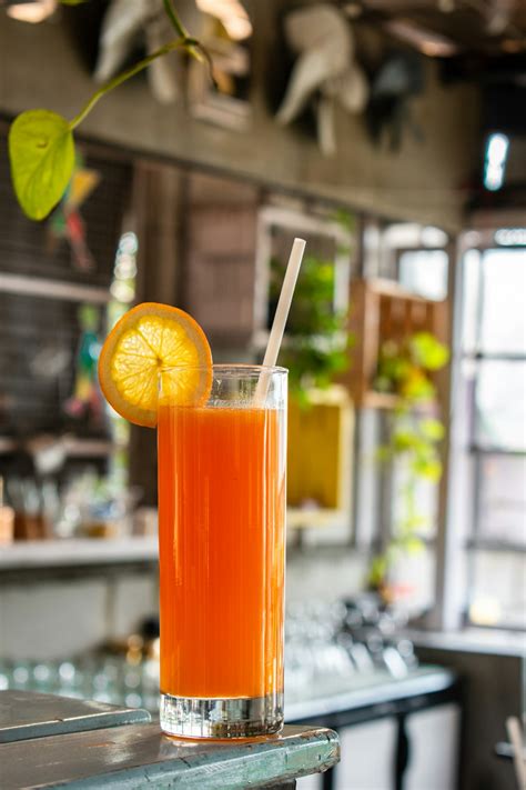 Orange Juice In Clear Drinking Glass With Sliced Lemon Photo Free