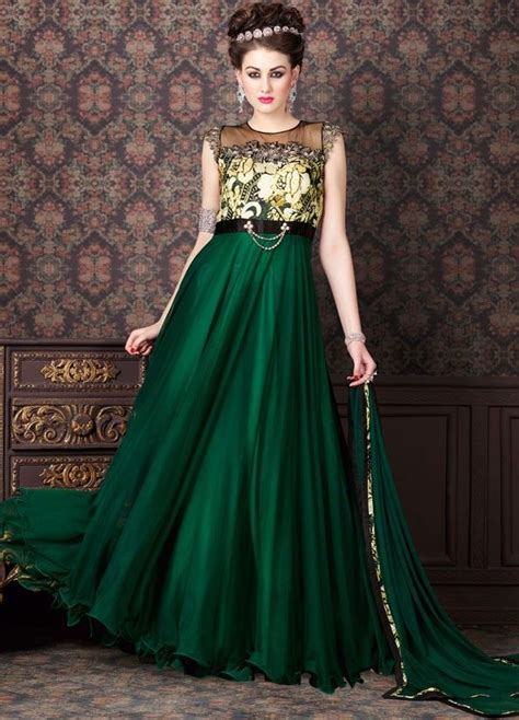 A perfect piece of heavy designer fancy gown featuring satin silk and net fabric embellished with floral thread and zari embroidery handwork and stone work. Enigmatic Bottle Green Anarkali Suit | Casual gowns, Silk ...