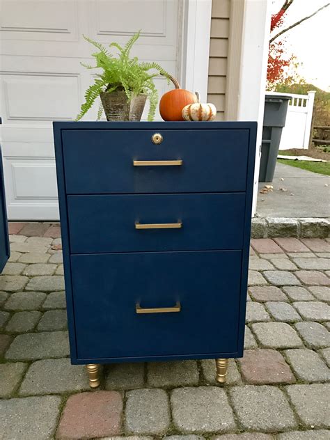 Please note stocked finish prior to ordering hpl sample. Deep navy filing cabinet with metallic gold hardware ...