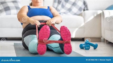 Overweight Lady Doing Sports Exercise In Living Room He Lies On The