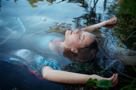 Young Beautiful Drowned Woman In Blue Dress Lying In The River Stock