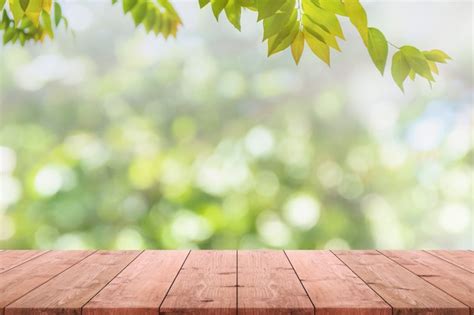 Premium Photo Empty Wood Table Top And Blurred View From Green Tree