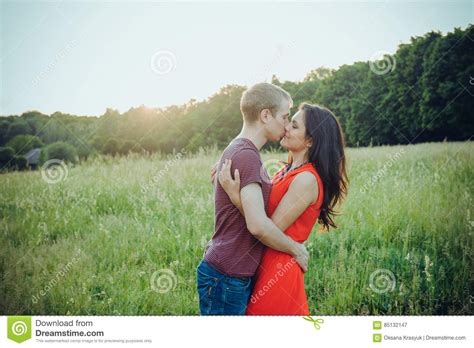 Happy Young Adult Couple In Love Kissing On The Green Field Stock Image Image Of Lifestyle