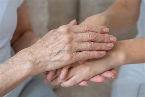 An Elderly Mother Calms Her Daughter Strokes Her Holds Her Hand In
