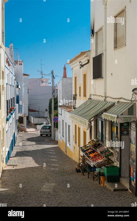 Narrow Street In The Fishing Village Of Burgau In The Algarve Portugal