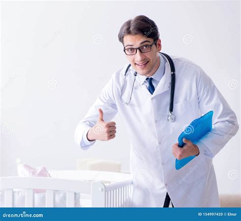 Man Male Pediatrician Near Baby Bed Preparing To Examine Stock Photo